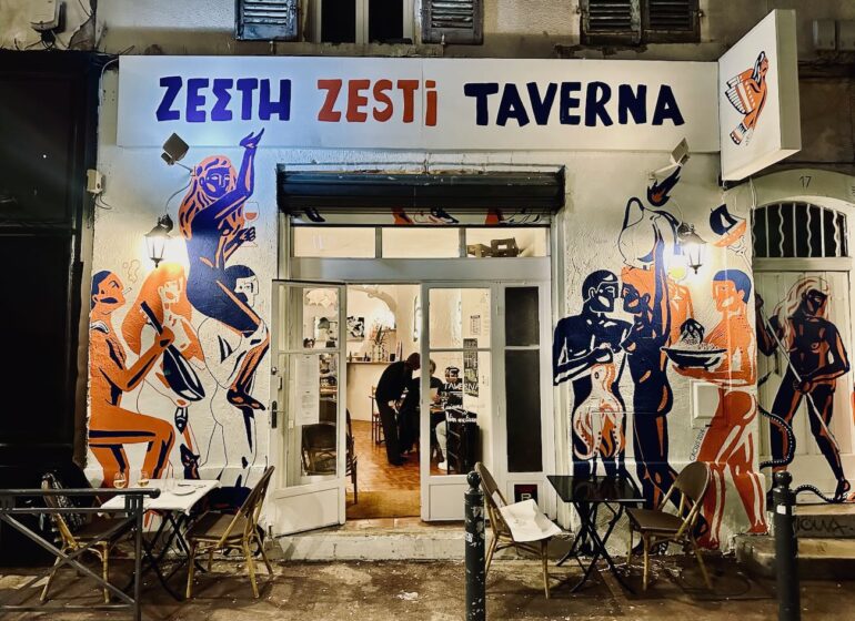 Zesti Taverna est un restaurant grec situé dans le quartier du Cours Julien à Marseille. On y sert des petites assiettes à partager, des vins grec et français, mais aussi du Ouzo. (façade)