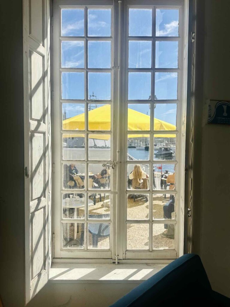 Le Café de la Consigne est un bar et une cantine ouvert du matin jus'à l'heure de l'apéro sur une terrasse d'un bâtiment historique du Vieux-Port : la consigne sanitaire (fenêtre)